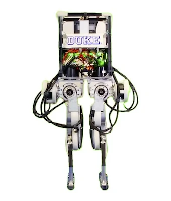 Duke Humanoid V1 bipedal robot seen from the front, with DUKE printed on the torso frame, exposed wiring and two geared legs — Humanoid & General Purpose